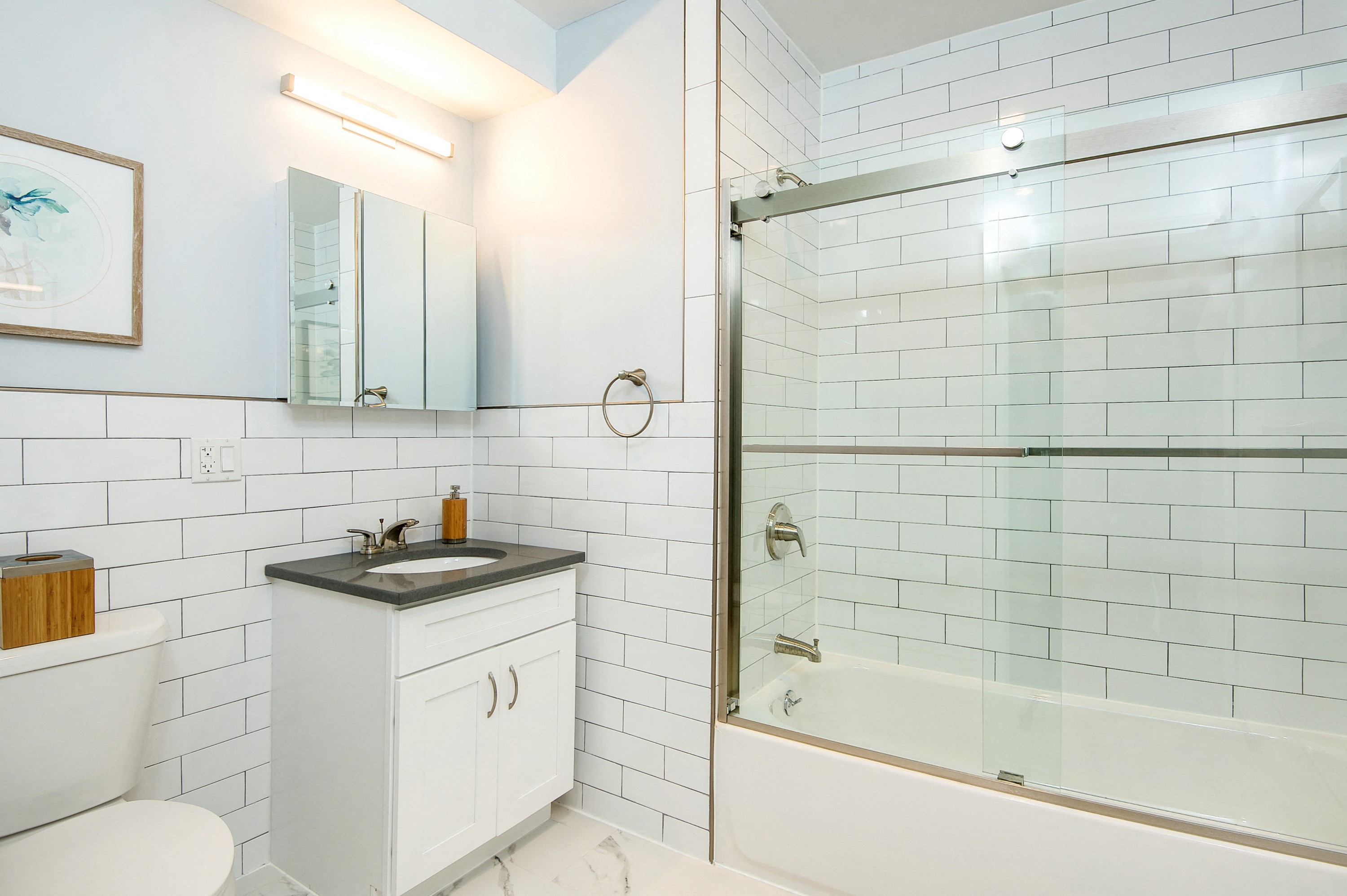 a white bathroom with a shower and a sink