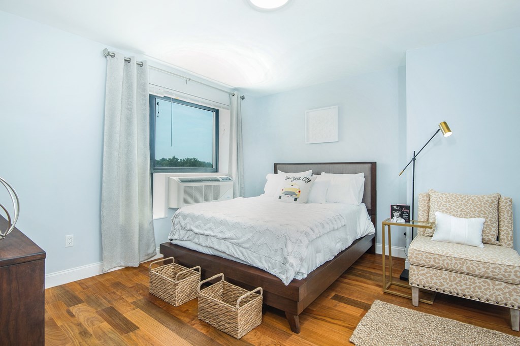 a bedroom with a bed and a window