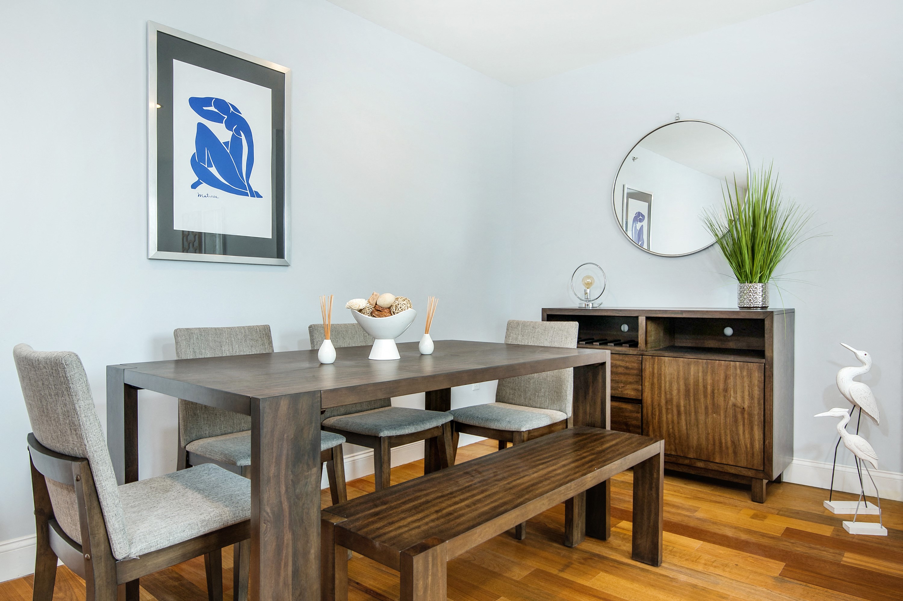 a dining room with a wooden table and chairs