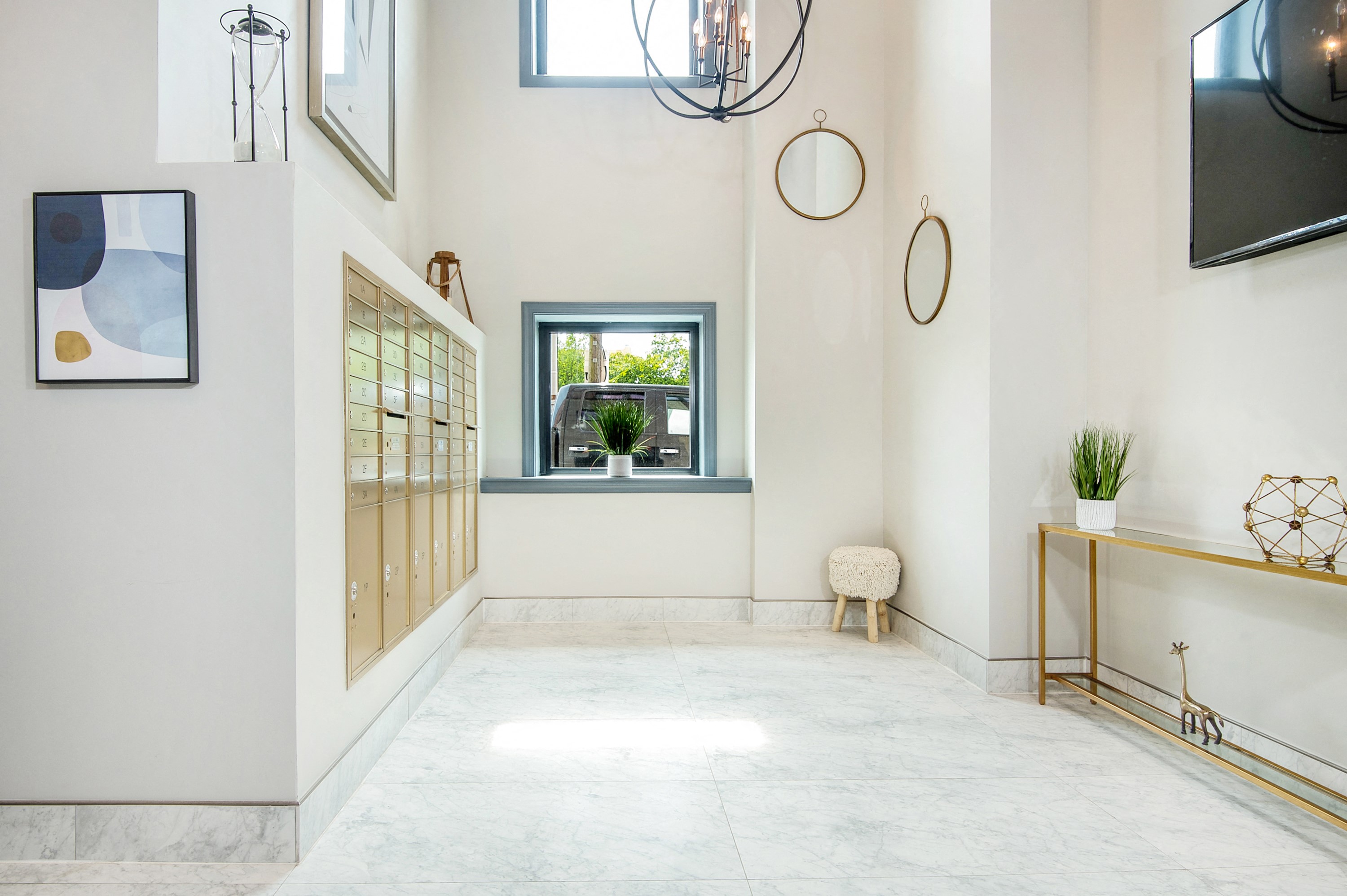 a long white room with a window and a seating area