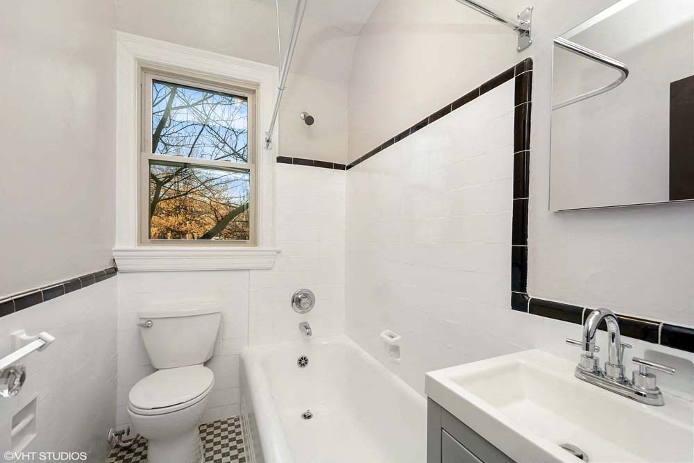 a bathroom with a toilet and a bath tub