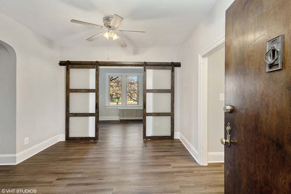 a bedroom with a ceiling fan and a window