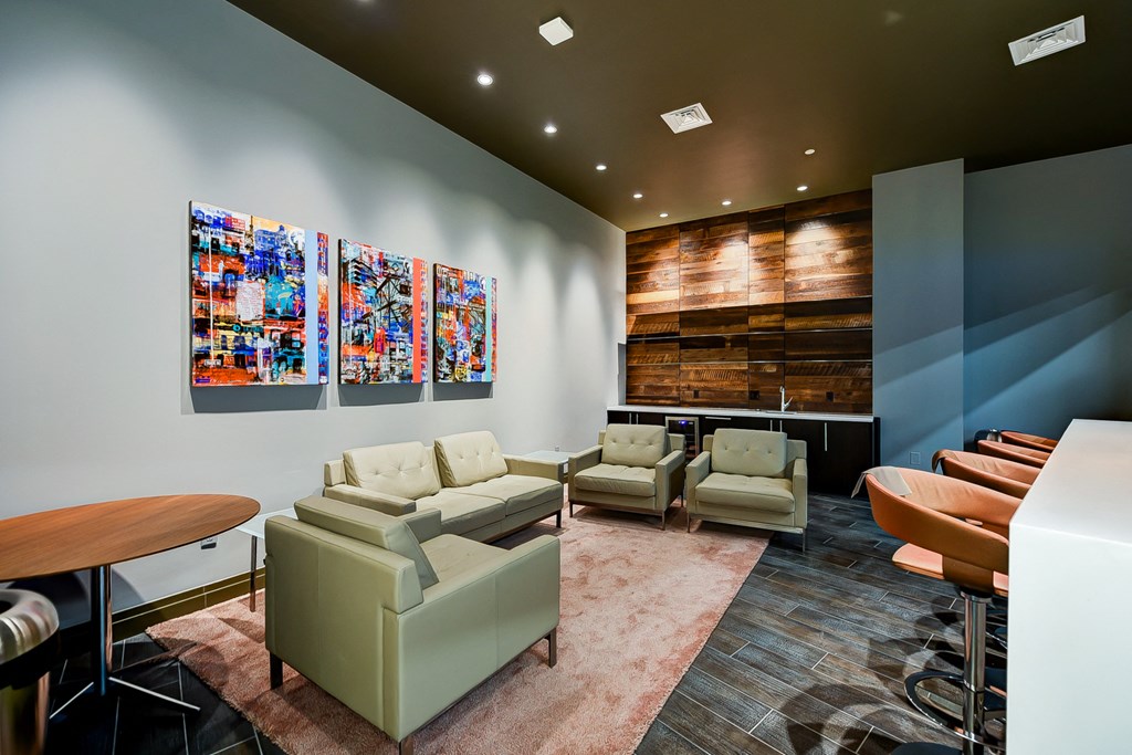 a lounge area with couches and chairs and a table