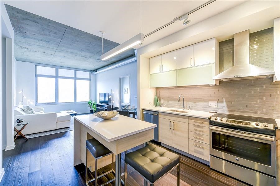 a kitchen and living room with a table and chairs