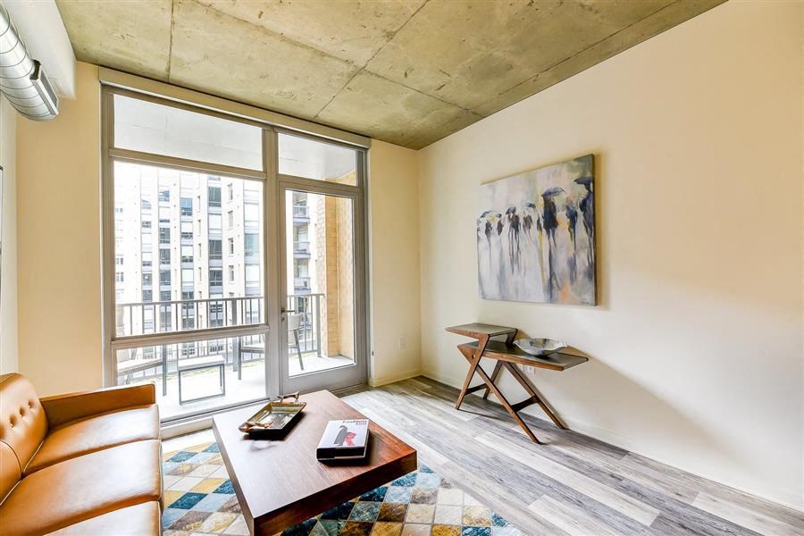 a living room with a couch and a table    and a large window