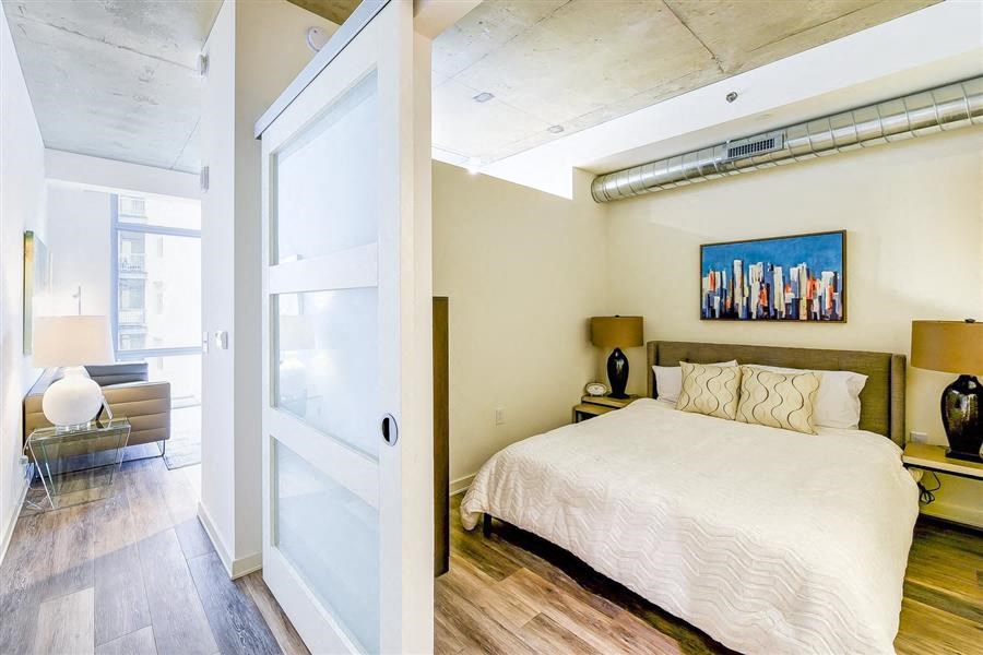 a bedroom with a bed and a sliding glass door