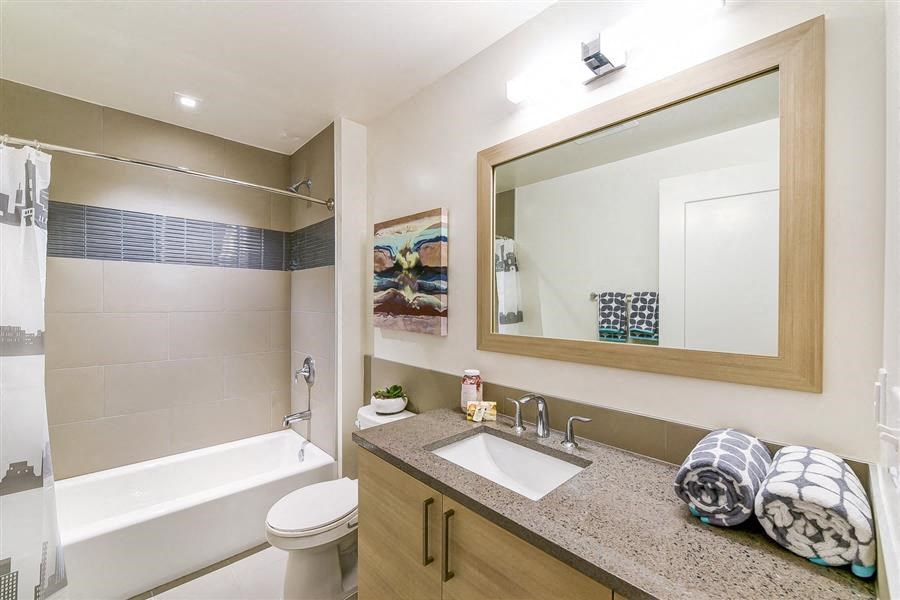 a bathroom with a sink toilet and a mirror