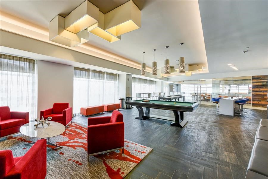 a large room with a pool table and chairs
