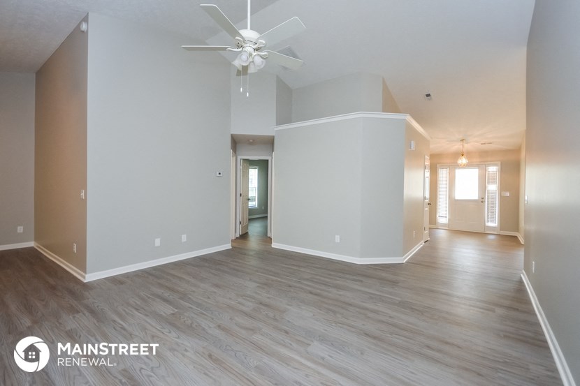 the living room and dining room of an open floor plan