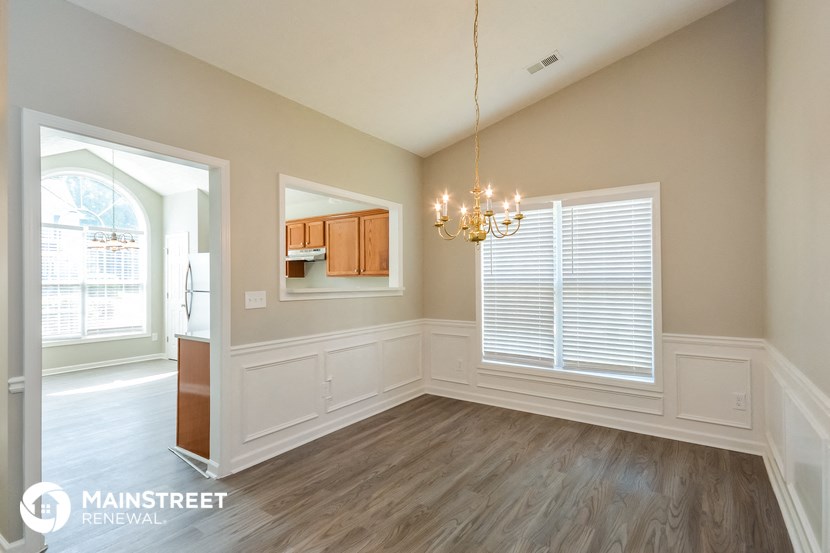a dining room with a chandelier and a window