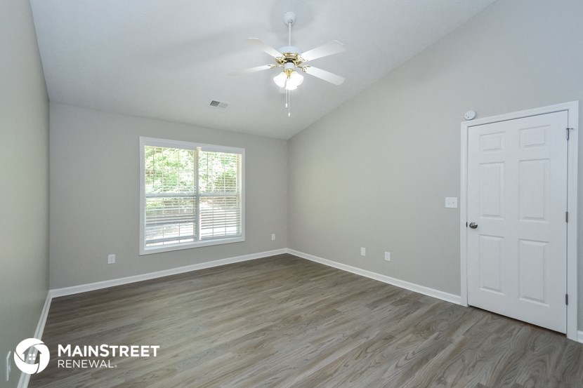 the master bedroom is spacious and has a ceiling fan