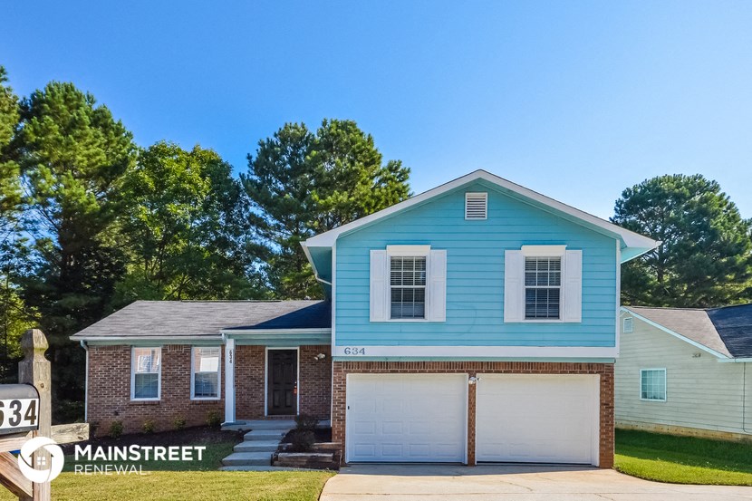 a blue house with a white garage door