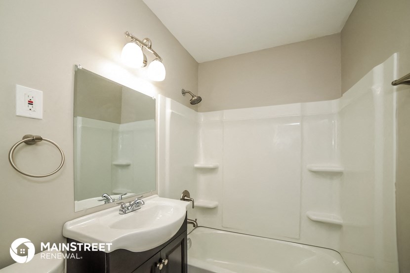 a bathroom with a sink and a bath tub and a mirror