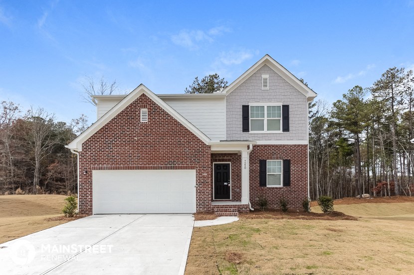 a large brick house with a white garage door