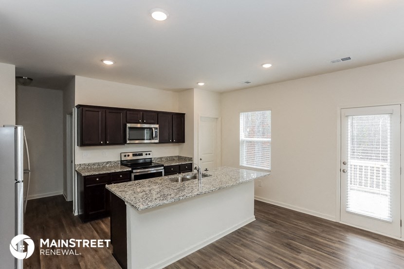the kitchen of an apartment with a granite counter top and