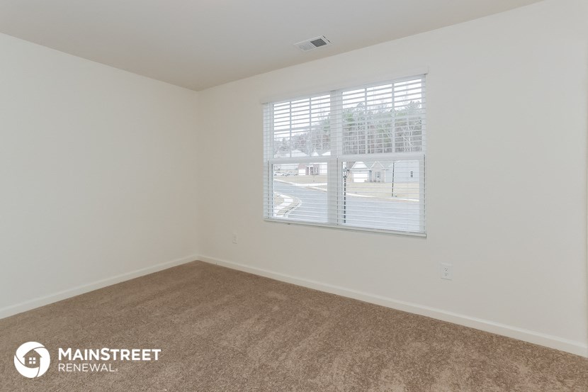 the living room of an apartment with a large window
