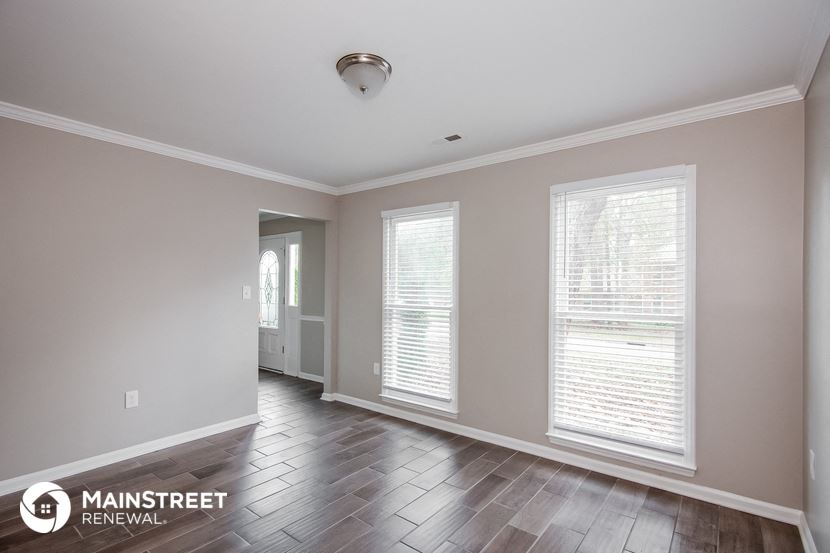 the living room of a new home with windows and wood flooring