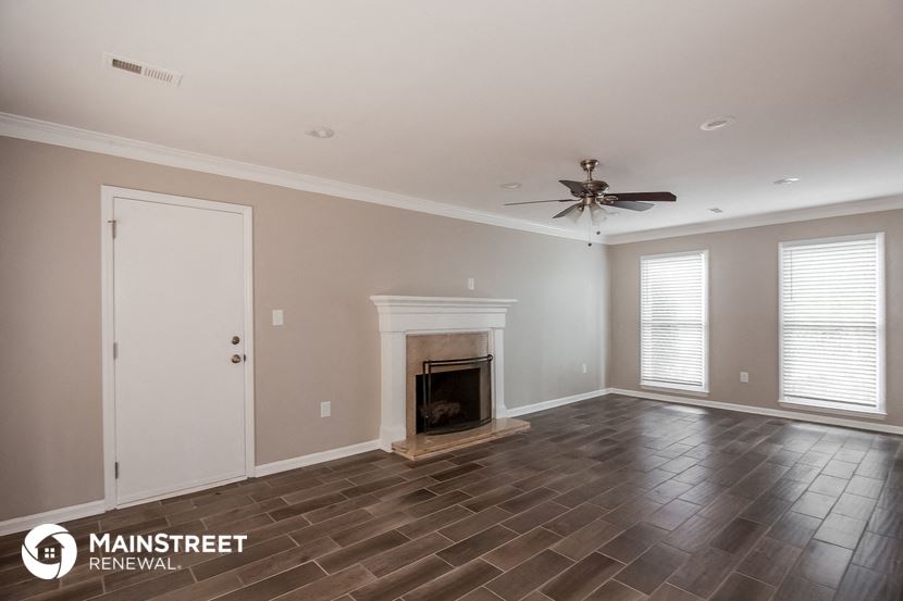 the living room of a new home with a fireplace