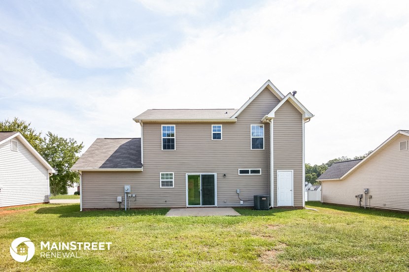 the front of a house with a yard and a driveway