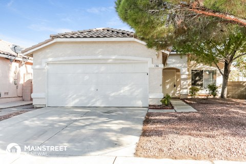 a garage door in front of a house with a tree