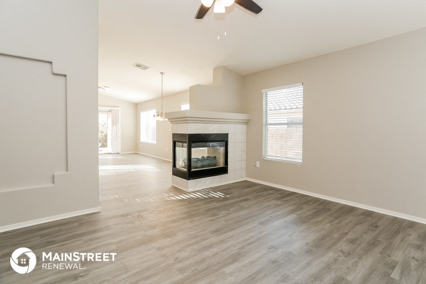 the living room has a fireplace and hardwood floors