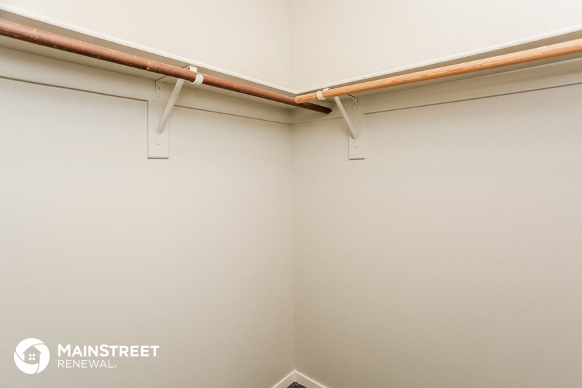 a room with white walls and a pipe on the ceiling