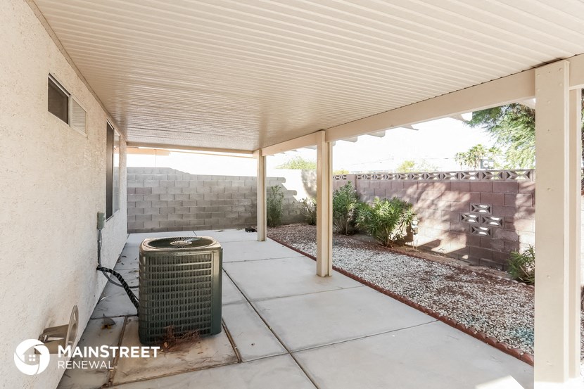 a covered patio with a heater in the corner of a house