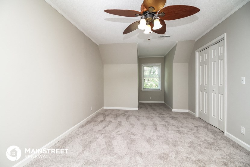 the master bedroom is spacious and has a ceiling fan