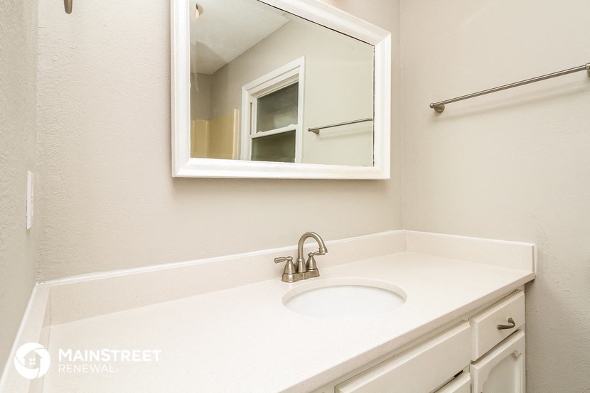 a bathroom with a sink and a mirror