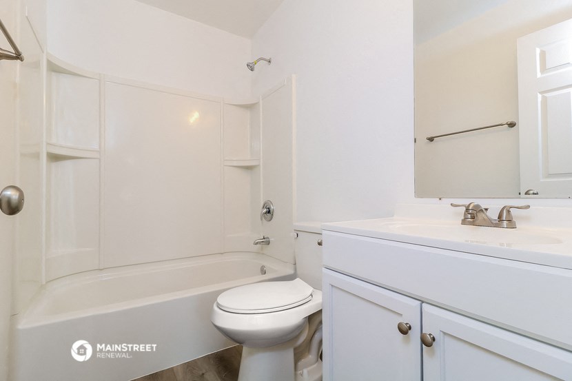 a bathroom with a sink and a toilet and a bath tub