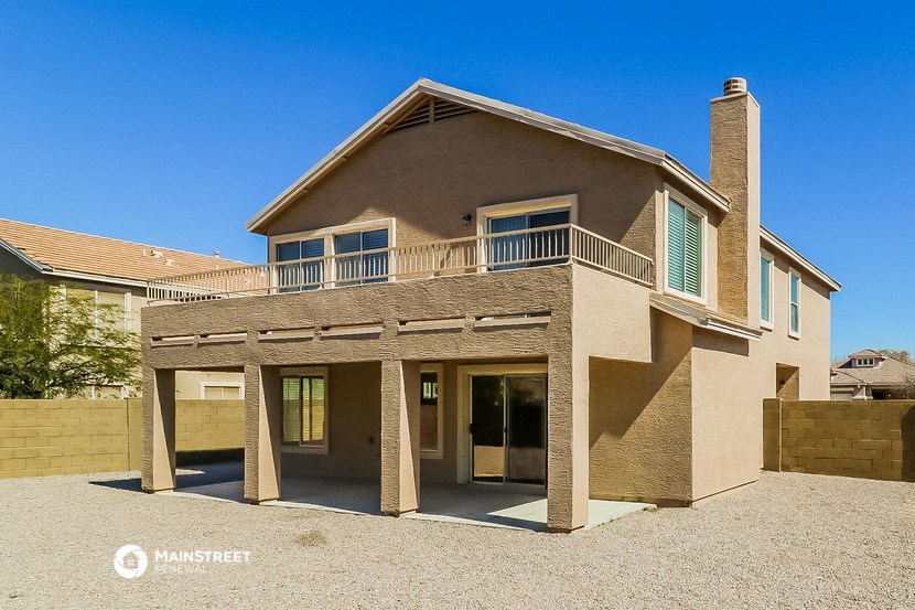 a brick house with a porch and a balcony