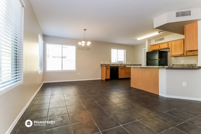 the view of the kitchen and living room from the dining room