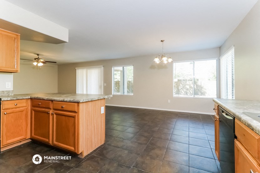 the kitchen and living room of an empty house