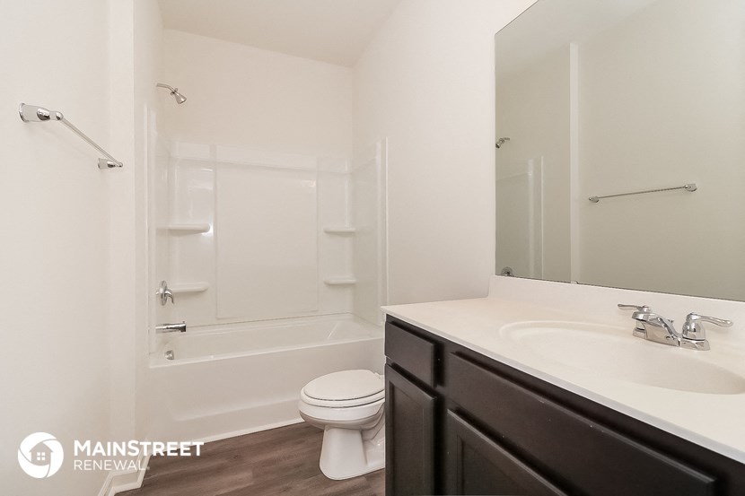 a bathroom with a sink and a toilet and a shower