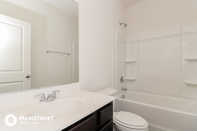 a bathroom with a sink and a toilet and a shower