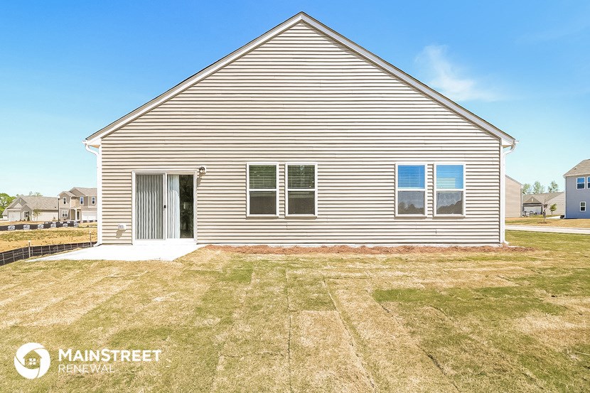 a small house with a yard in front of it