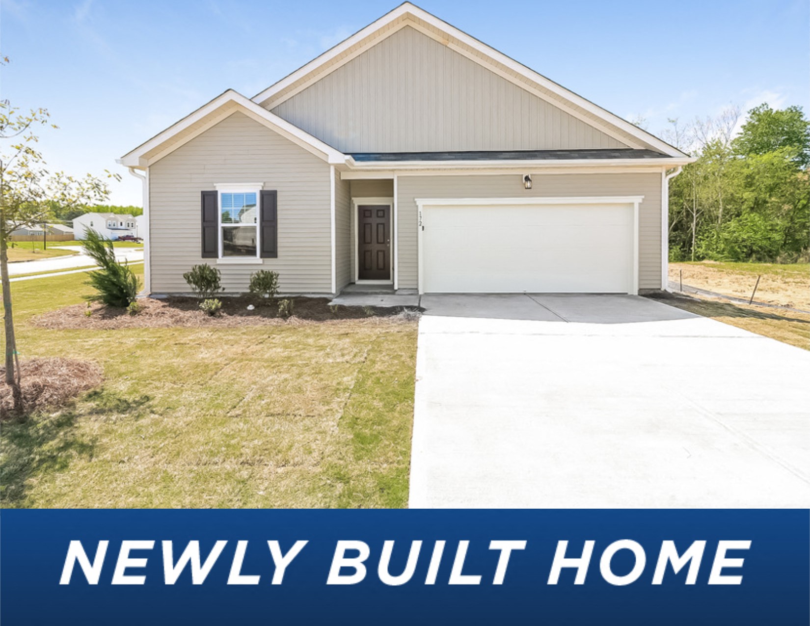 a small beige house with a white garage door