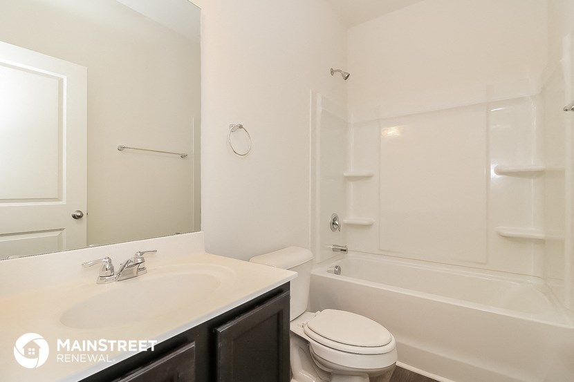 a bathroom with a sink and a toilet and a bath tub