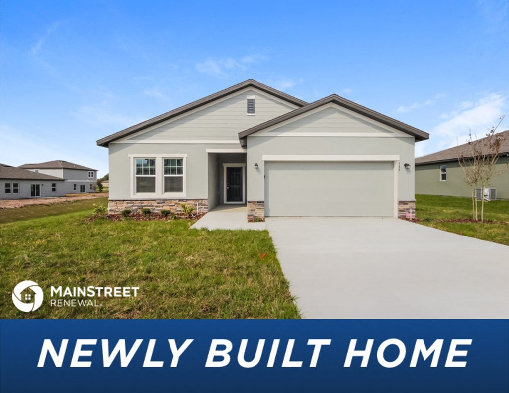 a new build home in front of a yard with grass