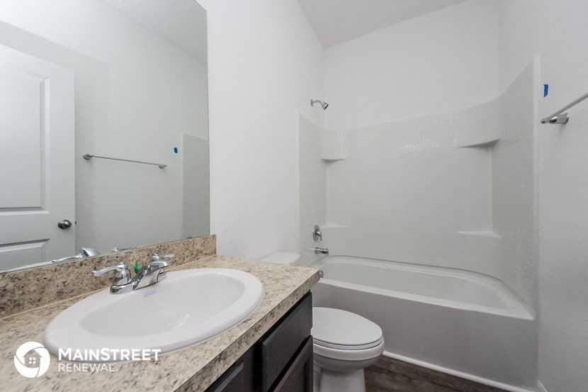 a bathroom with a sink and a tub and a toilet