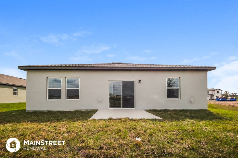 the exterior of a small house with a yard and grass