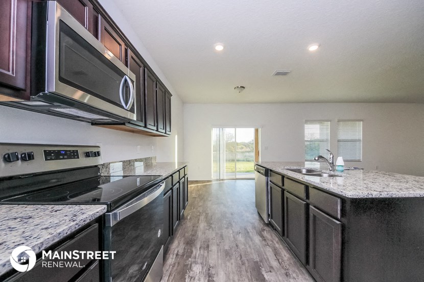 a kitchen with marble counter tops and stainless steel appliances