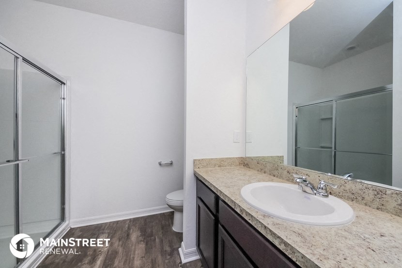 a bathroom with a sink and a shower and a toilet
