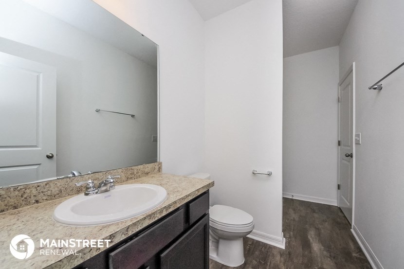 a bathroom with a sink and a toilet and a mirror