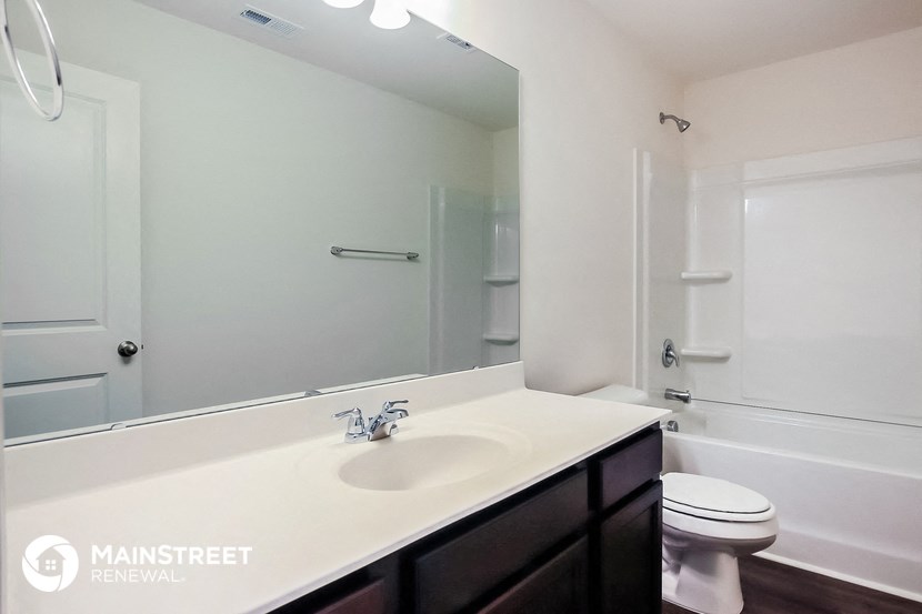 a bathroom with a sink and a toilet and a mirror