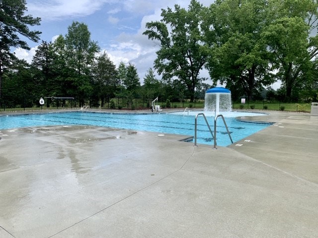 a swimming pool with a water fountain