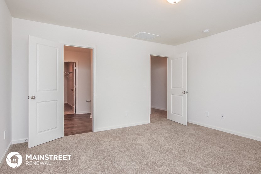a bedroom with two closets and a door to a hallway