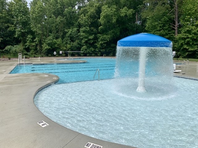 a water fountain in the middle of a pool