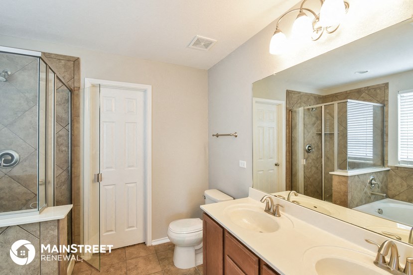 a bathroom with a sink and a toilet and a shower