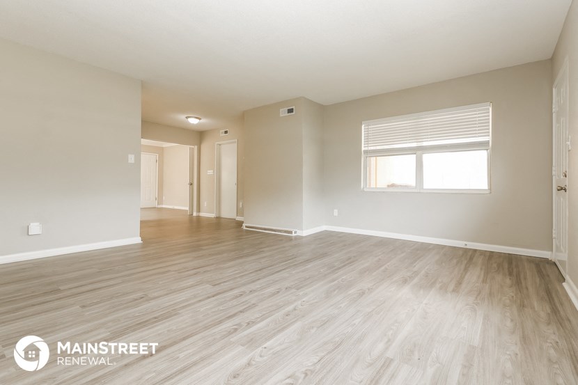 the living room and dining room of an apartment